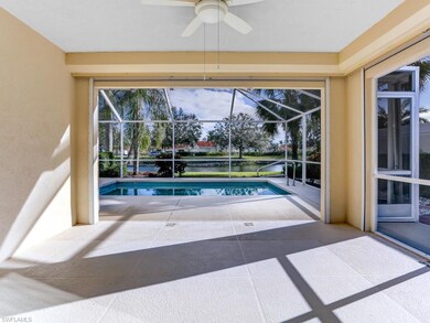 Covered lanai space has electric roll down shutters and great sunny Southern view of the pool and lake
