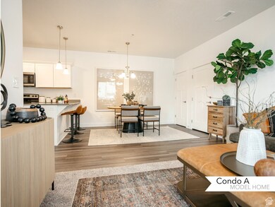Living room featuring baseboards, visible vents, wood finished floors, and a chandelier