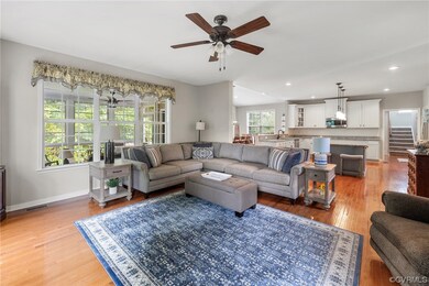 Hardwood floored family room featuring ceiling fan