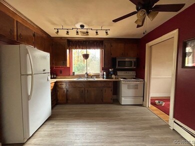 Kitchen with white appliances, sink, ceiling fan,