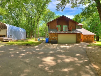 View of front facade with driveway, stone siding, 