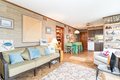 Living room with ornamental molding, ceiling fan, 