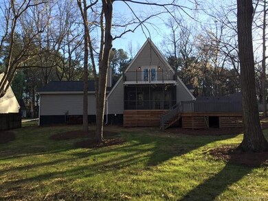 Rear of home boasts a large balcony over a screene