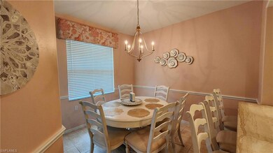 Dining area with a chandelier and tile patterned floors