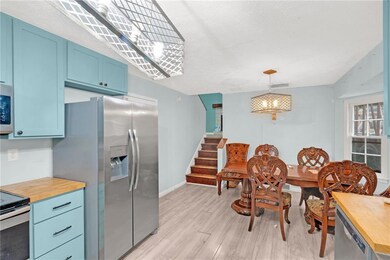 Dining area featuring stairway, baseboards, light 