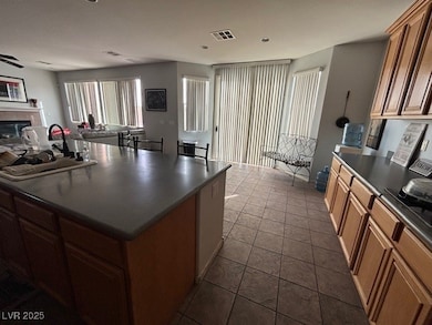 Kitchen with a fireplace, dark countertops, visibl
