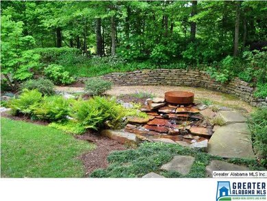 CALMING WATER FEATURE THAT FLOWS INTO A STREAM THA