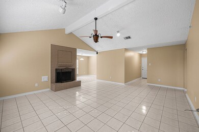 Foyer opens to large family room with fireplace. Breakfast area can be seen in rear of picture.