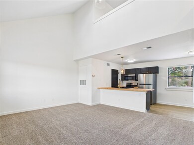 Unfurnished living room featuring light carpet and