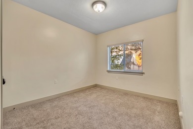 Carpeted spare room with baseboards