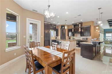 Dining area featuring an inviting chandelier and light tile patterned floors
