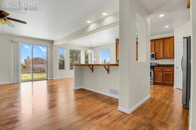 Living room with light hardwood / wood-style floor