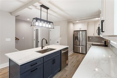 Another view of the living room, dining area and kitchen - virtually staged