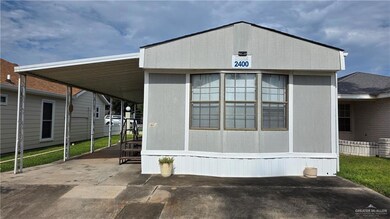 Manufactured / mobile home featuring driveway and an attached carport