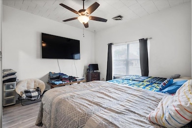 Bedroom featuring wood finished floors and a ceil
