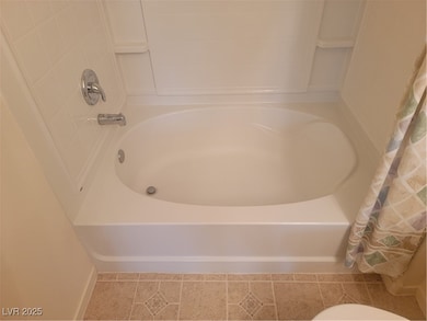 Full bathroom with baseboards and toilet
