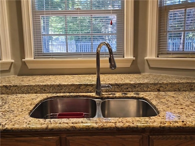 Kitchen view of light stone countertops and a sink