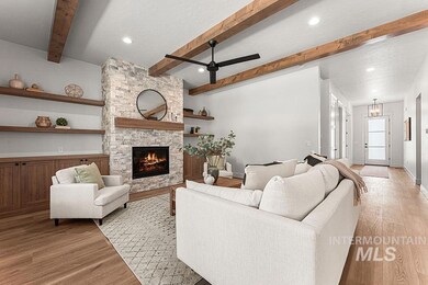 Living room with a ceiling fan, light wood-style flooring, beam ceiling, a stone fireplace, and recessed lighting
