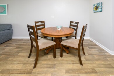 Dining space featuring light wood-type flooring and baseboards