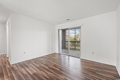 Unfurnished room featuring dark wood-style floorin