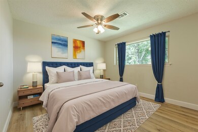 Spacious primary bedroom with fresh paint. Room is