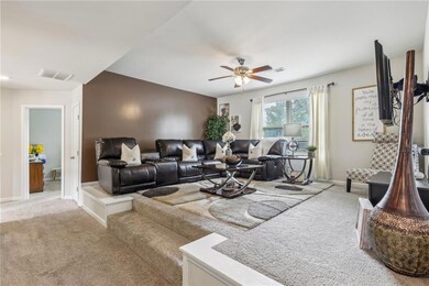 Carpeted living room featuring baseboards, a ceili