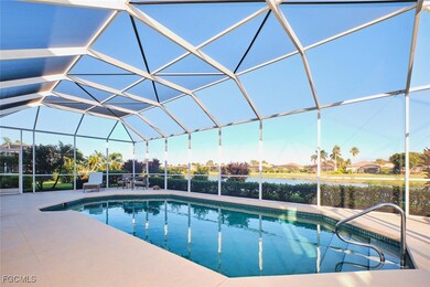 Swimming pool featuring glass enclosure, a sunroom, and a patio area
