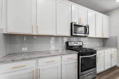 Kitchen featuring stainless steel appliances, whi