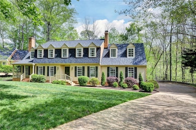 New england style home featuring a chimney and a f