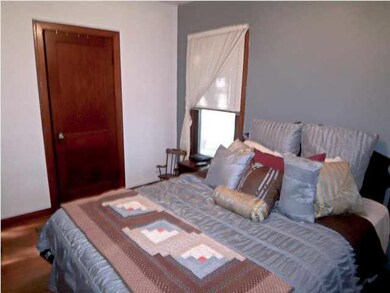 Bedroom with hardwood flooring