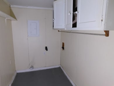Laundry room featuring cabinet space, washer hookup, and electric panel
