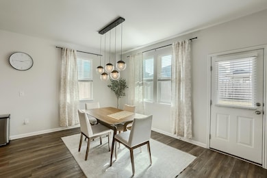 Dining space with dark wood-type flooring and bas