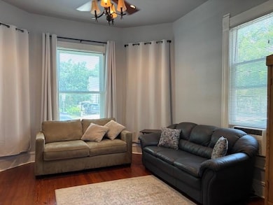 Living room with dark wood finished floors, plent