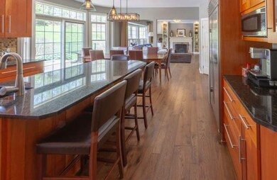 View from kitchen to family room with wood burning