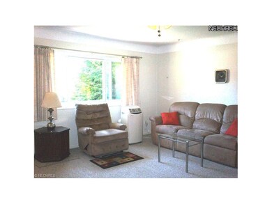THE LIVING ROOM HAS TWO WINDOWS FOR NATURAL LIGHTI