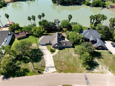 Aerial perspective of suburban area featuring a nearby body of water