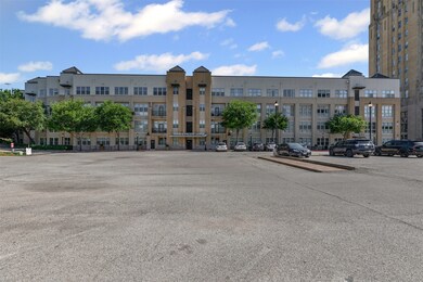 View of apartment building / complex featuring uncovered parking