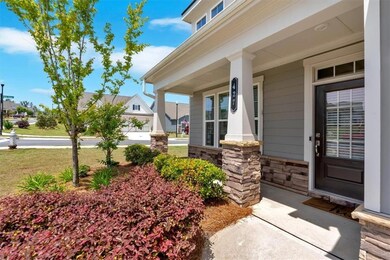 Entrance to property with stone siding and a porch