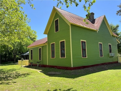 Back and side of home yard, metal roof