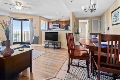 Dining area with light wood-type flooring, a chandelier, and ceiling fan