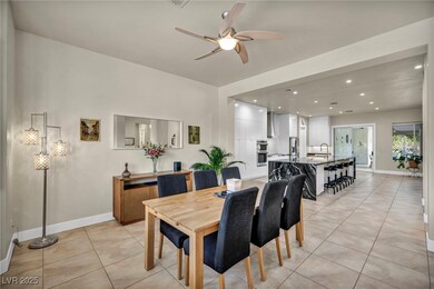 Dining room featuring baseboards, a ceiling fan, r