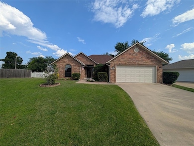 Ranch-style home with brick siding, driveway, and an attached garage