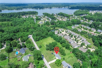 Aerial view of property's location with a nearby body of water and nearby suburban area