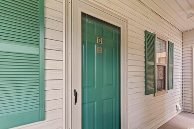 Doorway to property with covered porch