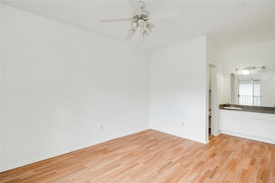 Spare room with a sink, ceiling fan, baseboards, 
