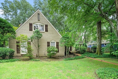 View of property exterior featuring a lawn
