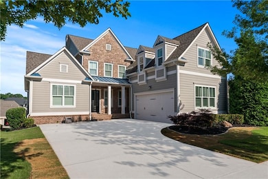 View of front of property with concrete driveway, covered porch, and a garage