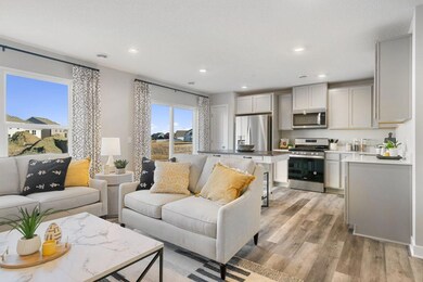 The rest of the main level pours out from the kitchen space, which flows straight into an open-concept styled living and dining area! (Photo of model, colors may vary)