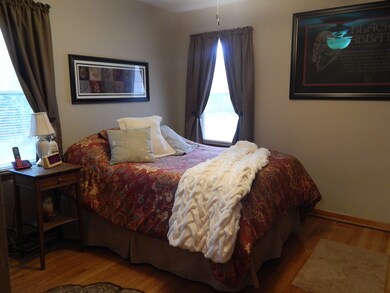 Master bedroom with mid century charm and hardwood