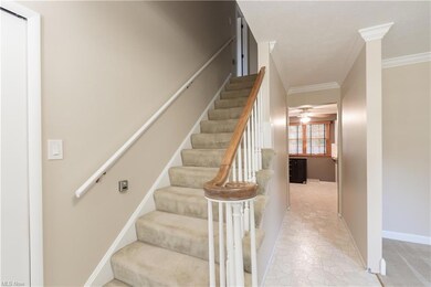 Stairway featuring light tile flooring, ceiling fa
